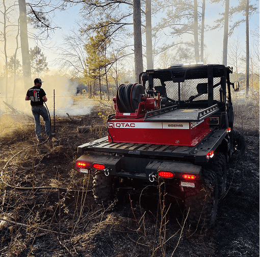 Heavy equipment and crew in wooded field