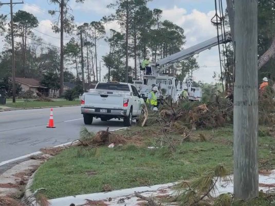 Storm debris removal along roadway after severe weather event
