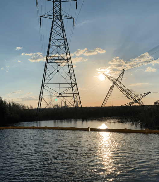 Storm-damaged utility poles and wires after hurricane
