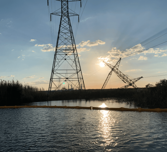 Storm-damaged utility poles and wires after hurricane