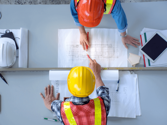 Engineers reviewing blueprints